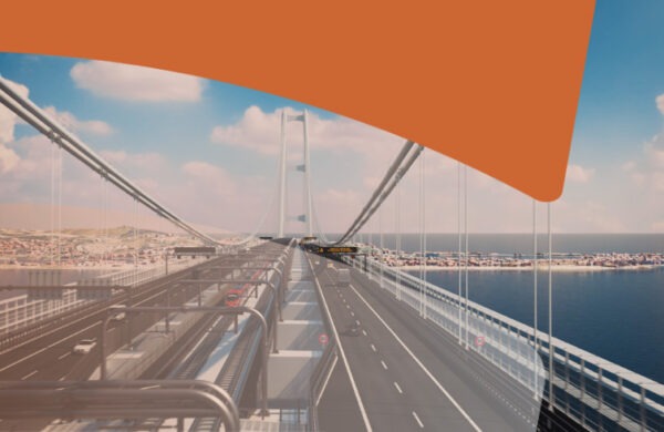 Aerial view of a suspension bridge over blue water, with multiple roadway lanes and a distant coastline beneath a partly cloudy sky, plus a large orange graphic at the top right corner (branding overlay).